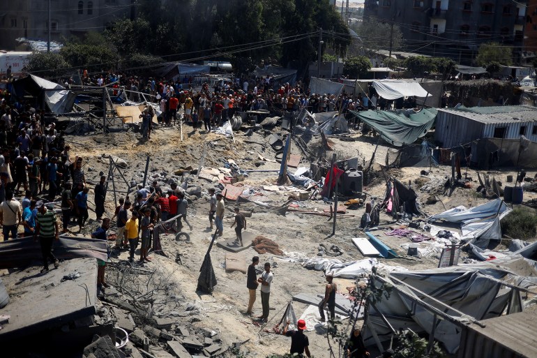 Palestinians inspect the damage, following what Palestinians say was an Israeli strike at a tent camp in Al-Mawasi area, amid Israel-Hamas conflict, in Khan Younis in the southern Gaza Strip July 13, 2024. REUTERS/Mohammed Salem