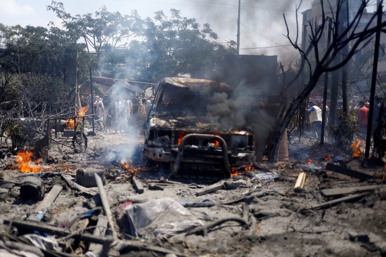 Palestinians gather near a burning vehicle, following what Palestinians say was an Israeli strike at a tent camp in Al-Mawasi area, amid Israel-Hamas conflict, in Khan Younis in the southern Gaza Strip July 13, 2024. REUTERS/Mohammed Salem