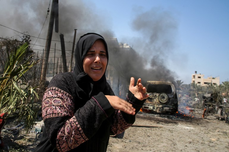 A woman reacts in the aftermath of what Palestinains say was an Israeli strike at a tent camp in Al-Mawasi area, amid Israel-Hamas conflict, in Khan Younis in the southern Gaza Strip July 13, 2024. REUTERS/Hatem Khaled