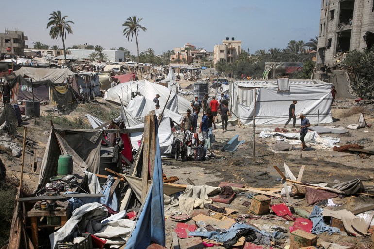 People check damages at the site of what Palestinians say was an Israeli strike at a tent camp in Al-Mawasi area, amid Israel-Hamas conflict, in Khan Younis in the southern Gaza Strip July 13, 2024. REUTERS/Hatem Khaled