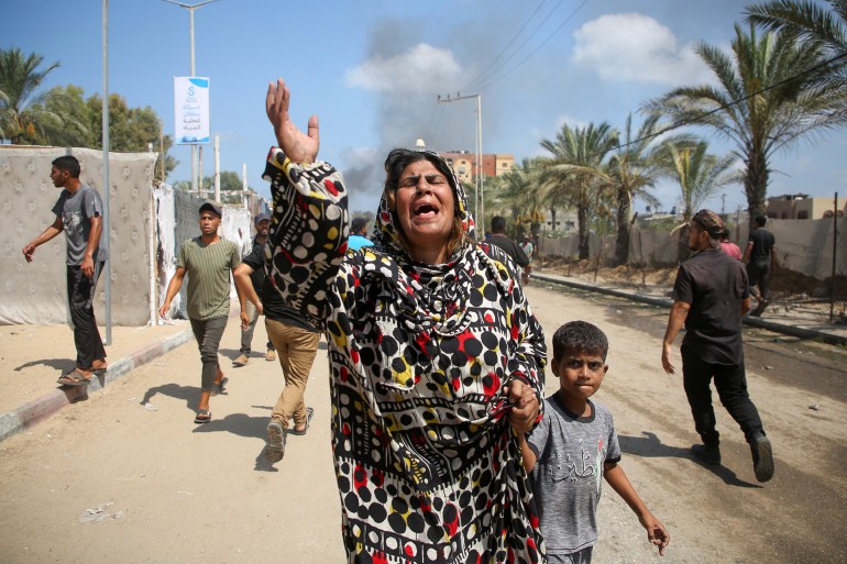 People reacts at the site of what Palestinians say was an Israeli strike at a tent camp in Al-Mawasi area, amid Israel-Hamas conflict, in Khan Younis in the southern Gaza Strip July 13, 2024. REUTERS/Hatem Khaled