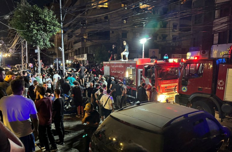 People gather near a site hit by what security sources said was a strike on Beirut's southern suburbs, Lebanon July 30, 2024. REUTERS/Mohamed Azakir