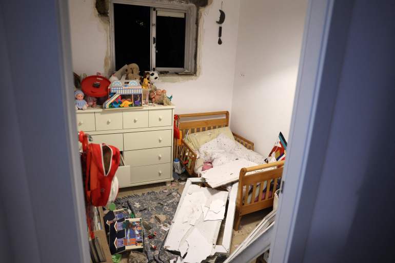 This picture shows debris in a bedroom in Tel Aviv early on December 21, 2024, after a projectile fired from Yemen landed near the building. Israel's military said on December 21, it had failed to intercept a "projectile" launched from Yemen that landed in Tel Aviv, with the national medical service saying 16 people were lightly wounded. Yemen's Iranian-backed Huthi rebels have repeatedly launched missile attacks against Israel since the war in Gaza began more than a year ago, most of which have been intercepted. (Photo by Jack GUEZ / AFP)