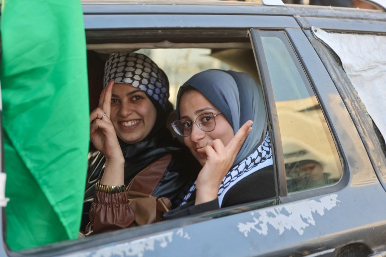 Two women smile as they ride in a car along a street in Gaza City on January 19, 2025, following the ceasefire deal in the Israel-Hamas war. A long-awaited ceasefire in the Israel-Hamas war was delayed January 19 after Prime Minister Benjamin Netanyahu said at the last minute that it would not take effect until the Palestinian militant group provided a list of the hostages to be released. (Photo by Omar AL-QATTAA / AFP)