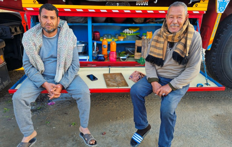 Egyptian drivers Labib Abdeen and Hatem Hamdan wait to break their fast as they sit next to food in a truck before Iftar, a fast-breaking meal, during the Muslim holy month of Ramadan, after Israel blocked the entry of aid through the borders, in the North Sinai city of Al Arish, Egypt, March 10, 2025. REUTERS/Stringer