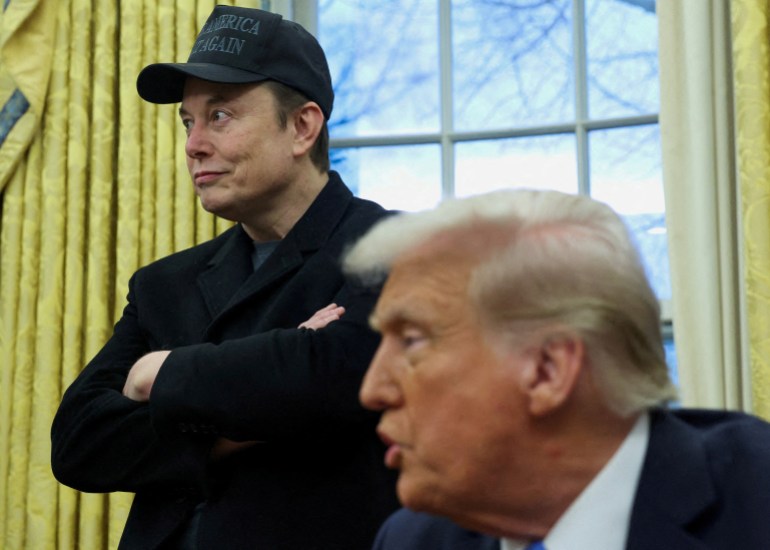 Elon Musk listens to U.S. President Donald Trump speak in the Oval Office of the White House in Washington, D.C., U.S., February 11, 2025. REUTERS/Kevin Lamarque
