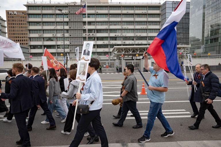 Over 200 members of the Coordinating Council of Russian Compatriot Organizations and other Russian residents in South Korea march in a Victory Day parade in front of the U.S. Embassy in Seoul, South Korea, on May 6, 2025. (Photo by Chris Jung/NurPhoto via Getty Images)