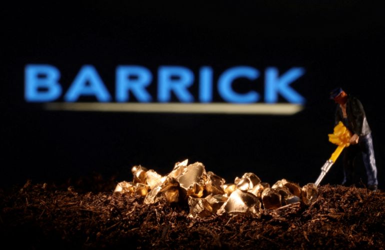 FILE PHOTO: A small toy figure and gold imitation are seen in front of the Barrick logo in this illustration taken November 19, 2021. REUTERS/Dado Ruvic/Illustration//File Photo