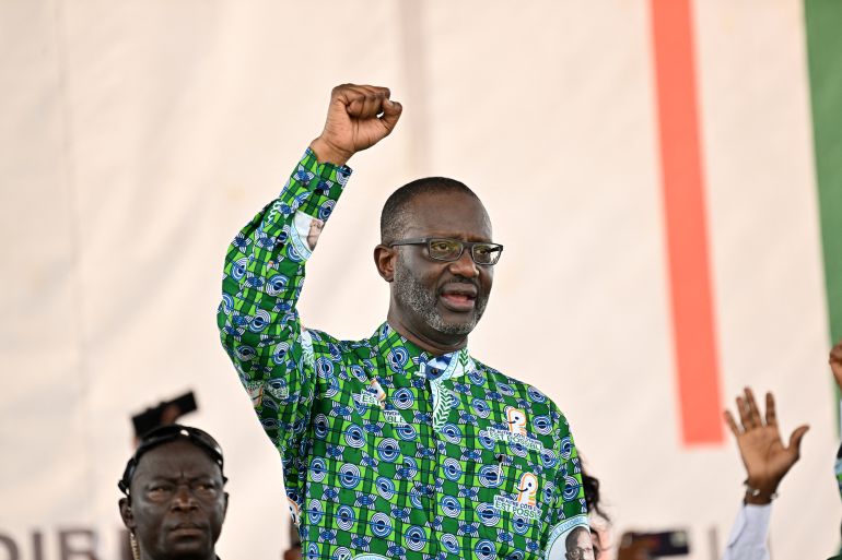 Tidjane Thiam, the president of the Democratic Party of Ivory Coast (PDCI), gestures during a mobilisation meeting for the presidential election of October 2025, in Yopougon, a popular commune in Abidjan on February 15, 2025. (Photo by Sia KAMBOU / AFP)
