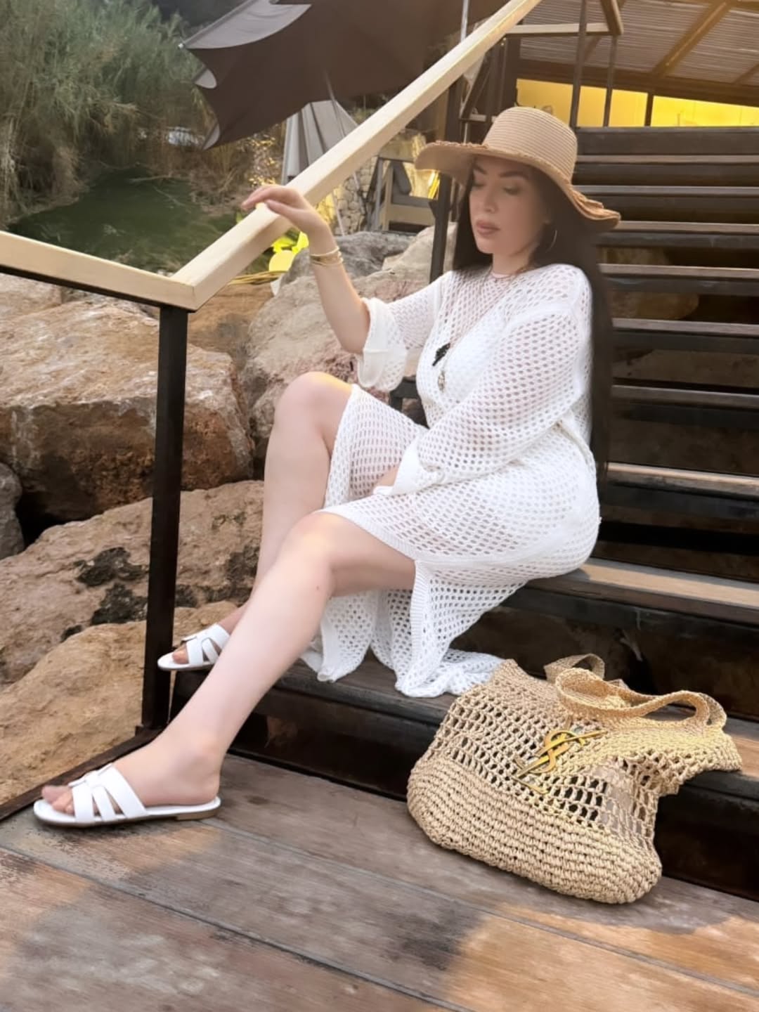 May be an image of 1 person, anklet, espadrilles and hat