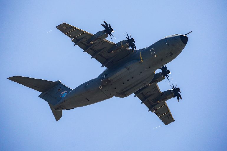 TOPSHOT - A German Air Force (Luftwaffe) A400M Atlas military transport aircraft flies over Nuseirat in the central Gaza Strip during a aid airdrop mission above the Israel-besieged Palestinian territory on August 5, 2025.