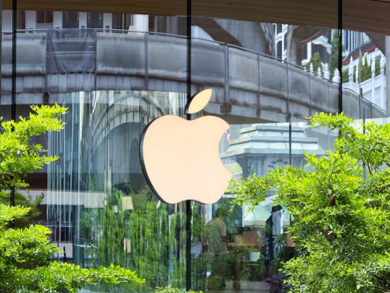 Bangkok, Thailand - June 21, 2025: Exterior Apple logo at Central World Apple Store reflecting lush greenery and architecture. High quality photo